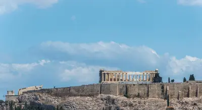 a building on a hill with a mountain in the background at Elegance in Athens in Athens