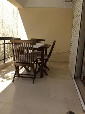 a patio with a table and two chairs on a porch at aris sweet home 2 in Athens