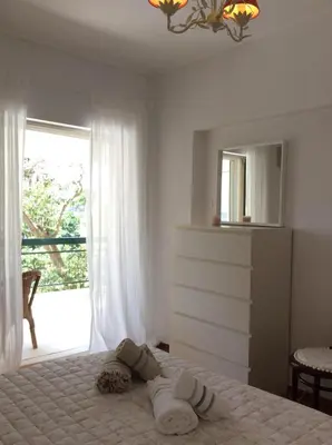 a bedroom with a bed and a large window at aris sweet home 2 in Athens