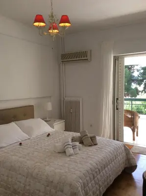 a bedroom with a large bed with towels on it at aris sweet home 2 in Athens