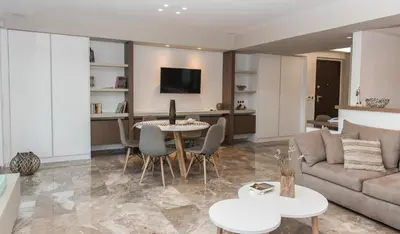 a living room with a couch and a table at Alex's place in Vari