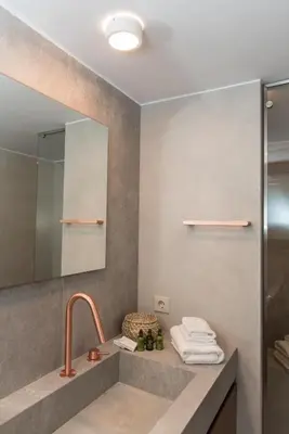 a bathroom with a sink and a mirror at Alex's place in Vari