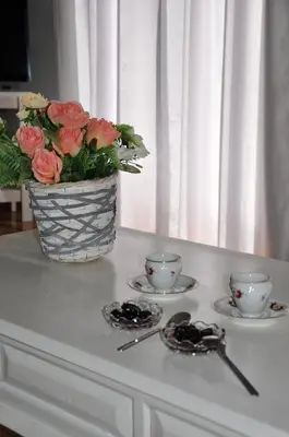 a vase of flowers sitting on a table with two cups at Athens Historic Centre Renovated Apartments in Athens
