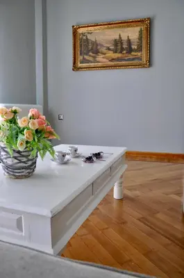 a white table with a vase of flowers on it at Athens Historic Centre Renovated Apartments in Athens