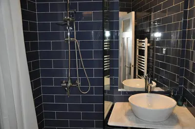 a blue tiled bathroom with two sinks and a shower at Athens Historic Centre Renovated Apartments in Athens