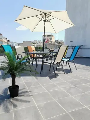 a patio with a table and chairs and an umbrella at Spacious 110m2 2bedrooms 2bathrooms Center Athens in Athens