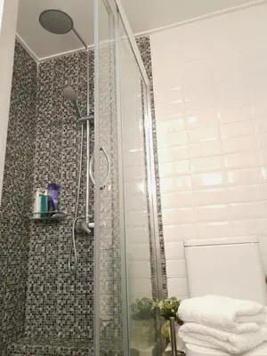 a bathroom with a shower with a toilet and towels at Spacious 110m2 2bedrooms 2bathrooms Center Athens in Athens