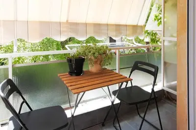 a small table and two chairs on a balcony at Tiny Studio Suite in Athens