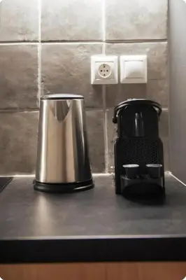 a black counter top with a coffee maker on it at Tiny Studio Suite in Athens