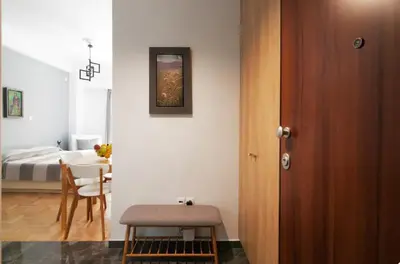 a room with a bed and a table and a room with a dining room at Tiny Studio Suite in Athens