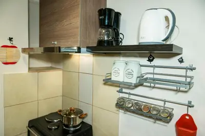 a kitchen with a stove and some shelves at AthensHub - Across Metro Station in Athens