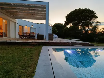 a house with a swimming pool in front of a house at Summer Villa in Porto Rafti in Porto Rafti