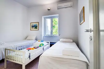 a room with two beds and a window at Summer Villa in Porto Rafti in Porto Rafti
