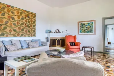 a living room with a couch and a fireplace at Summer Villa in Porto Rafti in Porto Rafti