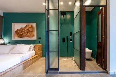 a bedroom with a bed and a green wall at Hidesign Athens Acropolis Panorama Suite in Athens