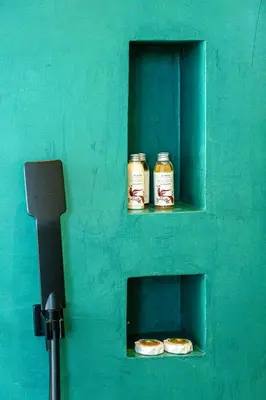 a green wall with two jars of food in a window at Hidesign Athens Acropolis Panorama Suite in Athens