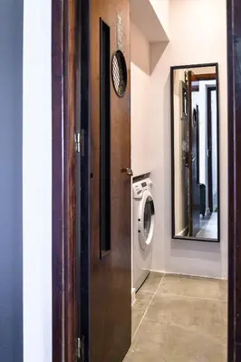 a bathroom with a washing machine and a mirror at Hidesign Athens Acropolis Panorama Suite in Athens