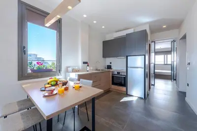 a kitchen with a table and a large window at Hidesign Athens Acropolis Panorama Suite in Athens