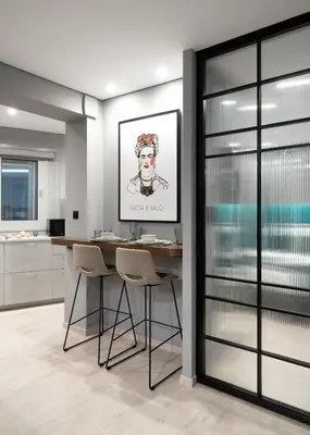 a kitchen with a table with chairs and a painting on the wall at Evripidou Suites in Athens