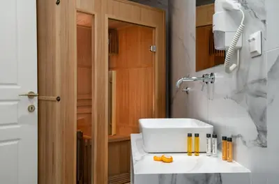 a bathroom with a white sink and a mirror at Evripidou Suites in Athens
