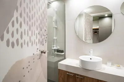 a bathroom with a sink and a mirror at Evripidou Suites in Athens