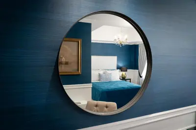 a mirror in a room with a blue bedroom at Evripidou Suites in Athens