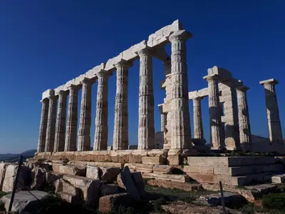 an ancient temple with columns on a hill at Alianthos Beach Apartment in Vari