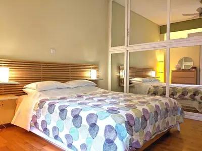 a bedroom with a large bed and a large mirror at Acropolis in Athens