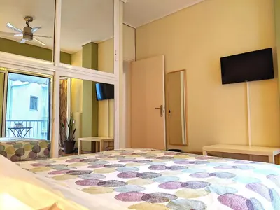 a bedroom with a bed and a flat screen tv at Acropolis in Athens