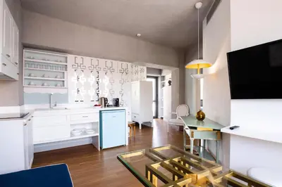 a kitchen with a glass table in a room at Downtown Athens Lofts by Raise in Athens