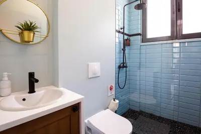 a bathroom with a sink and a toilet and a mirror at Downtown Athens Lofts by Raise in Athens