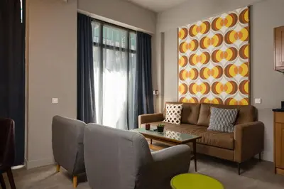 a living room with a couch and a table at Downtown Athens Lofts by Raise in Athens