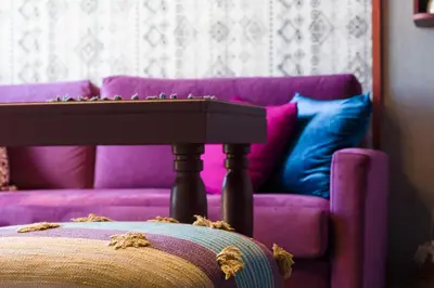 a living room with a purple couch and a table at Downtown Athens Lofts by Raise in Athens