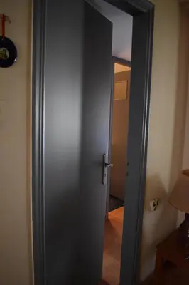 an open door in a room with a hallway at Katzen Room by the Metro in Athens