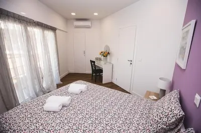 a bedroom with a bed with two towels on it at Gaspar Apartment - 4th floor - Renovated 2019 in Athens