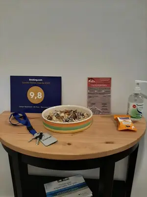 a wooden table with a bowl of nuts on it at Gaspar Apartment - 4th floor - Renovated 2019 in Athens