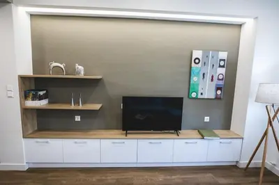 a living room with a tv on a wall at Gaspar Apartment - 4th floor - Renovated 2019 in Athens