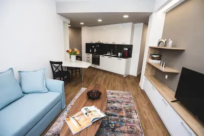 a living room with a blue couch and a table at Gaspar Apartment - 4th floor - Renovated 2019 in Athens