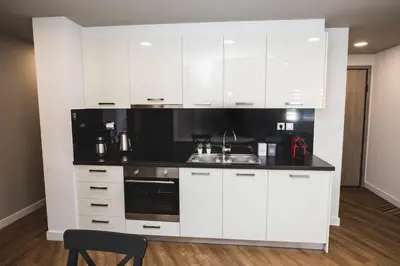 a kitchen with white cabinets and a sink at Gaspar Apartment - 4th floor - Renovated 2019 in Athens