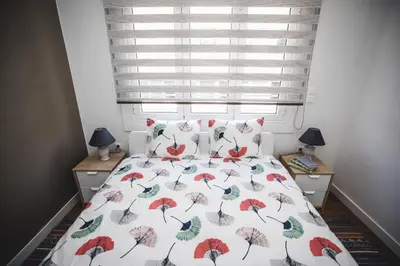 a bedroom with a bed with a floral bedspread at Ziva Apartment - 4th floor - Renovated 2019 in Athens