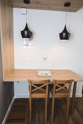 a kitchen with a wooden table and two chairs at Ziva Apartment - 4th floor - Renovated 2019 in Athens