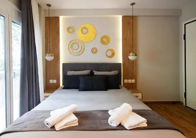 a bedroom with a large bed with two towels on it at Pame Rentals - Charming Central Studio in Athens