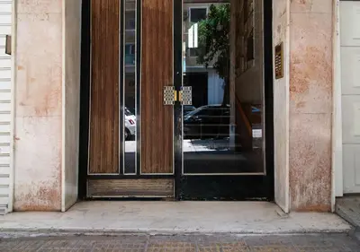 an entrance to a building with glass doors at Pame Rentals - Charming Central Studio in Athens