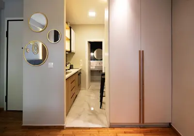 a kitchen with a sliding door leading into a bathroom at Pame Rentals - Charming Central Studio in Athens