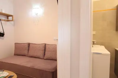 a living room with a couch and a sink at Your address in Koukaki by Athenian Homes in Athens