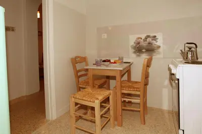 a kitchen with a small table and chairs in a room at Your address in Koukaki by Athenian Homes in Athens