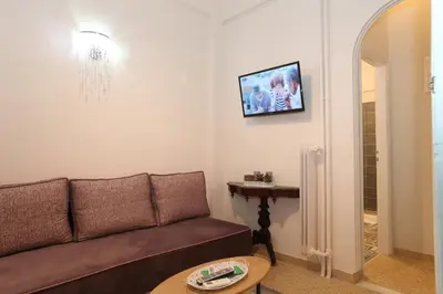 a living room with a couch and a table at Your address in Koukaki by Athenian Homes in Athens