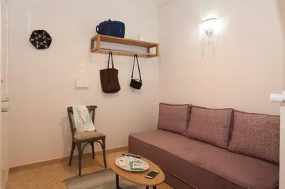a living room with a couch and a table at Your address in Koukaki by Athenian Homes in Athens