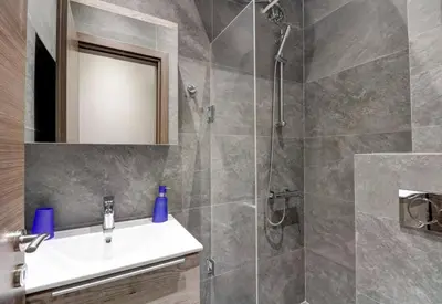 a bathroom with a sink and a shower at Classy and stylish apartment next to Hilton in Athens