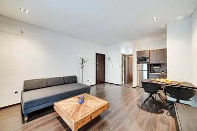 a living room with a couch and a table at Classy and stylish apartment next to Hilton in Athens